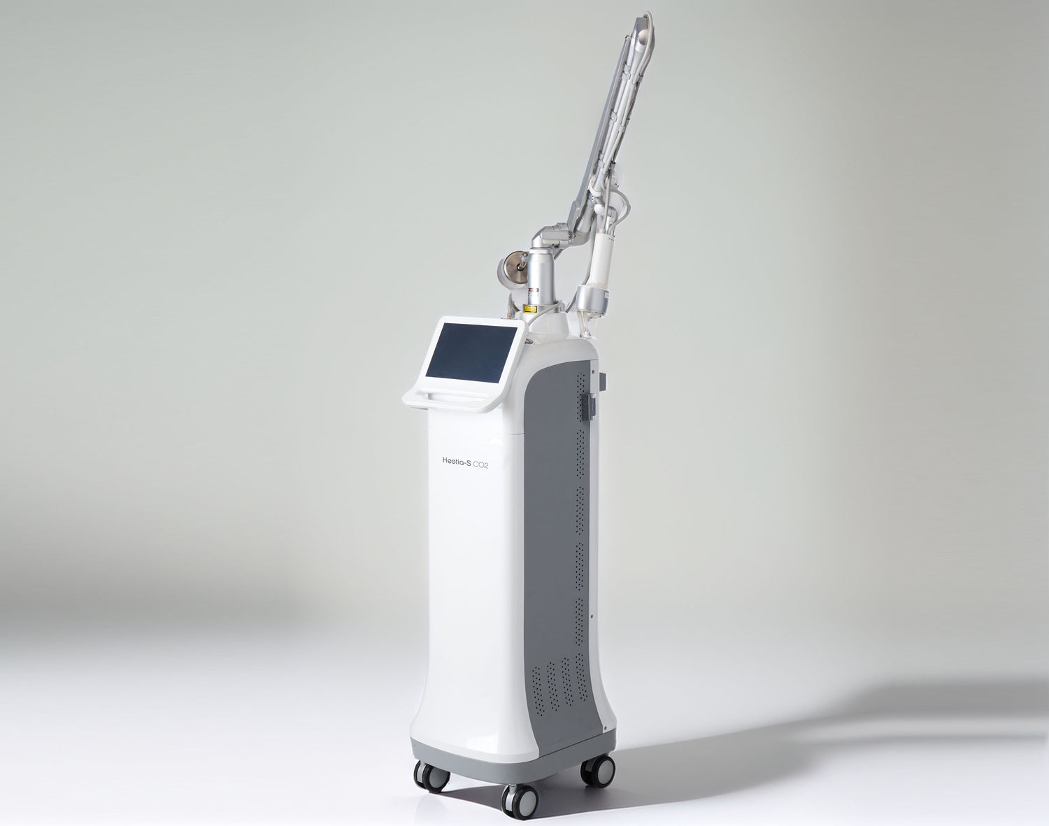 Hestia-S CO2 Fractional Laser machine for skin resurfacing, facing left, photographed in a professional studio with a clean white background