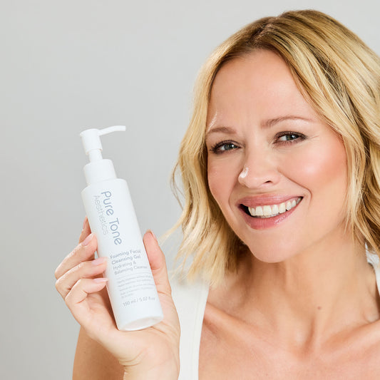 Close-up of Kimberley Walsh holding Pure Tone Aesthetics Foaming Facial Cleansing Gel
