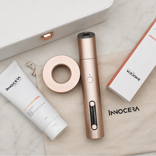 Innocera Max home skincare device and treatment accessories arranged on a marble surface