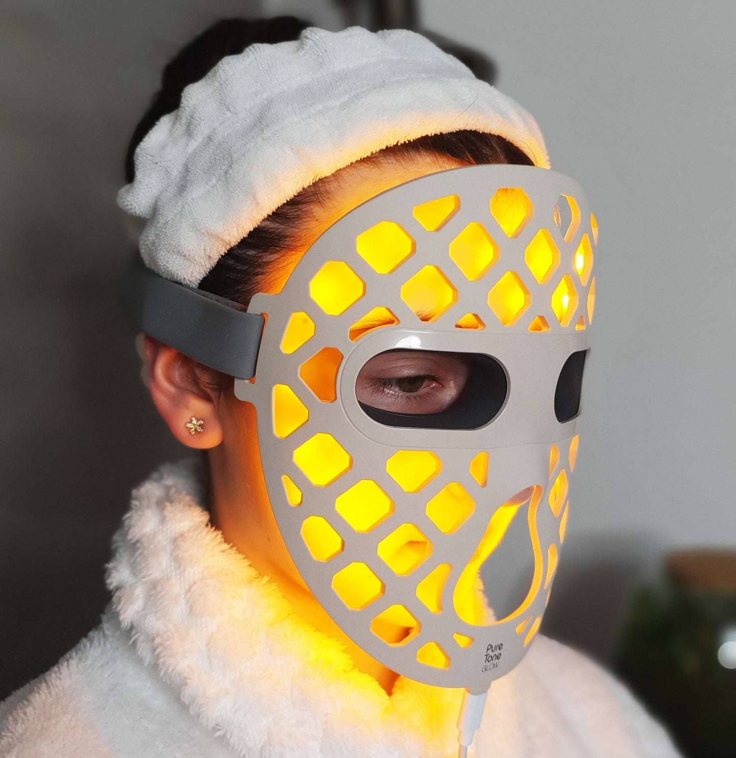 Person wearing a Pure Tone Glow LED face mask with a blurred background