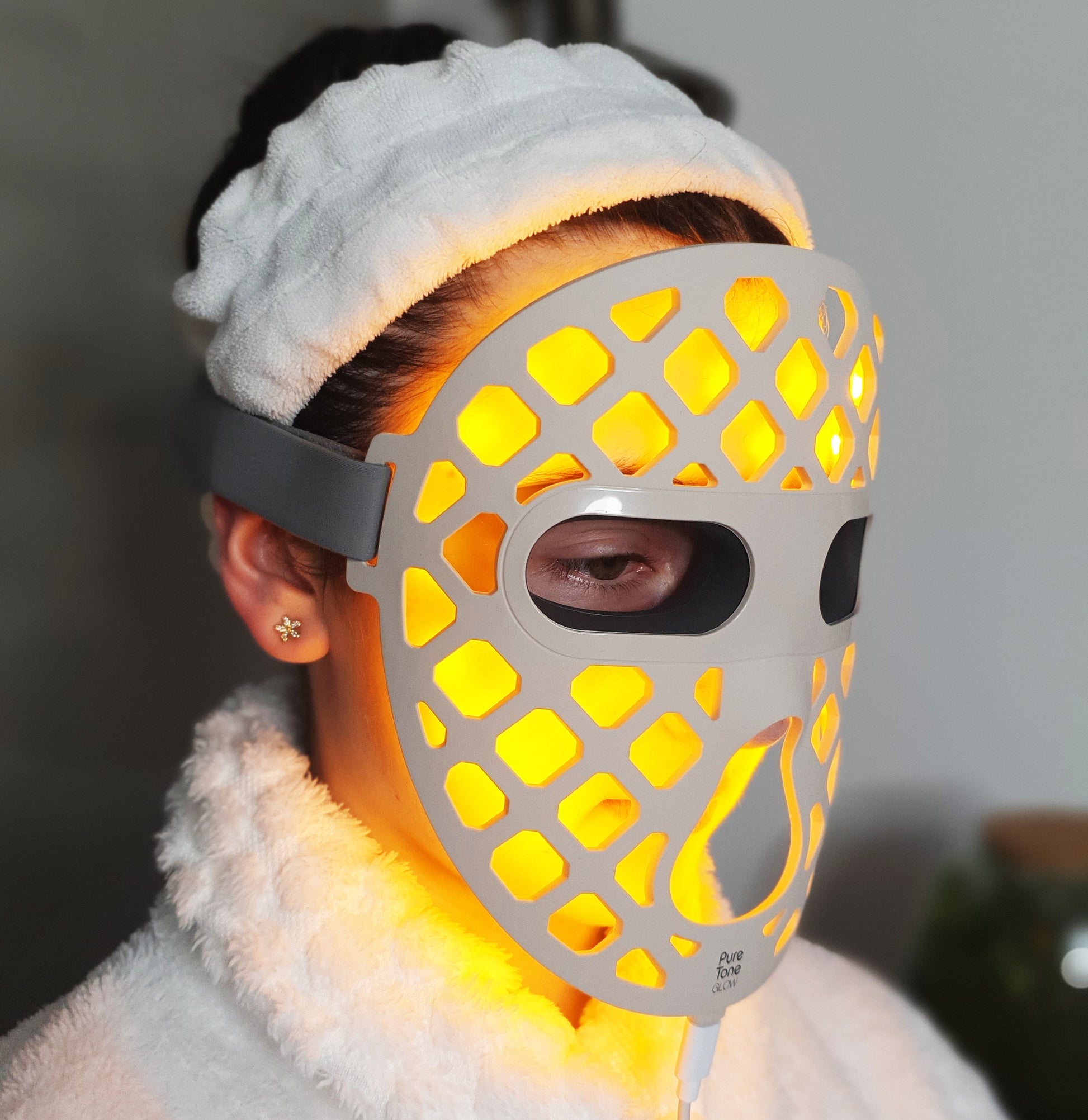 Person wearing a Pure Tone Glow LED face mask with a blurred background