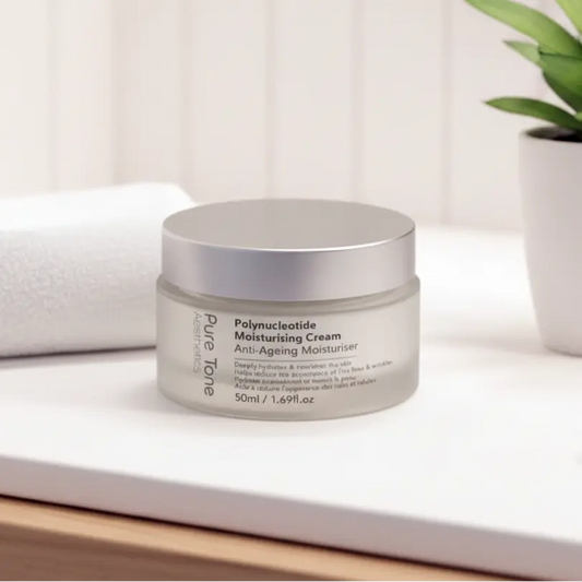Jar of Pure Tone Aesthetics polynucloetide anti-aging moisturizer on a white surface with a plant in the background