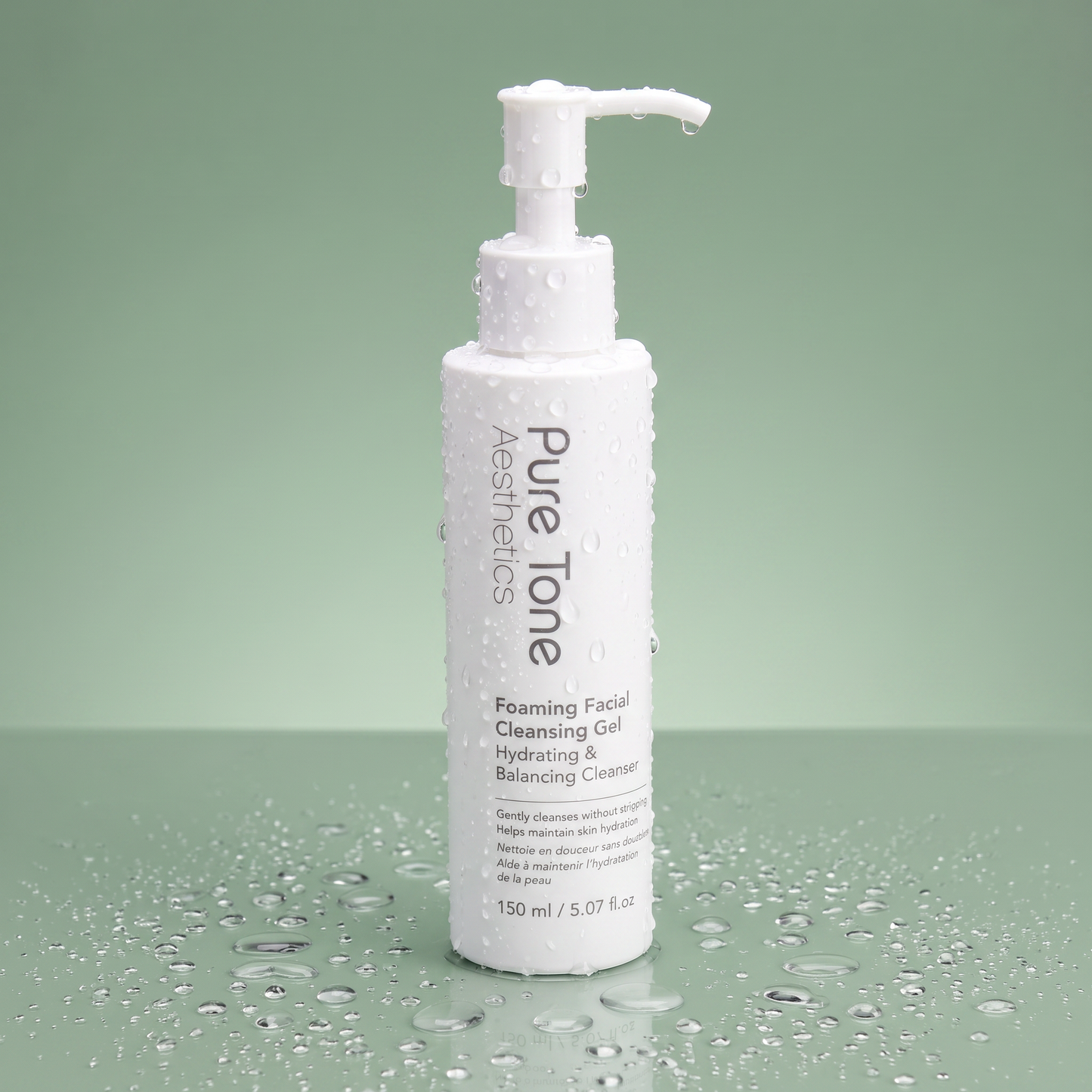 Pure Tone Aesthetics Foaming Facial Cleansing Gel standing on a reflective green surface with water droplets on the bottle and surrounding surface