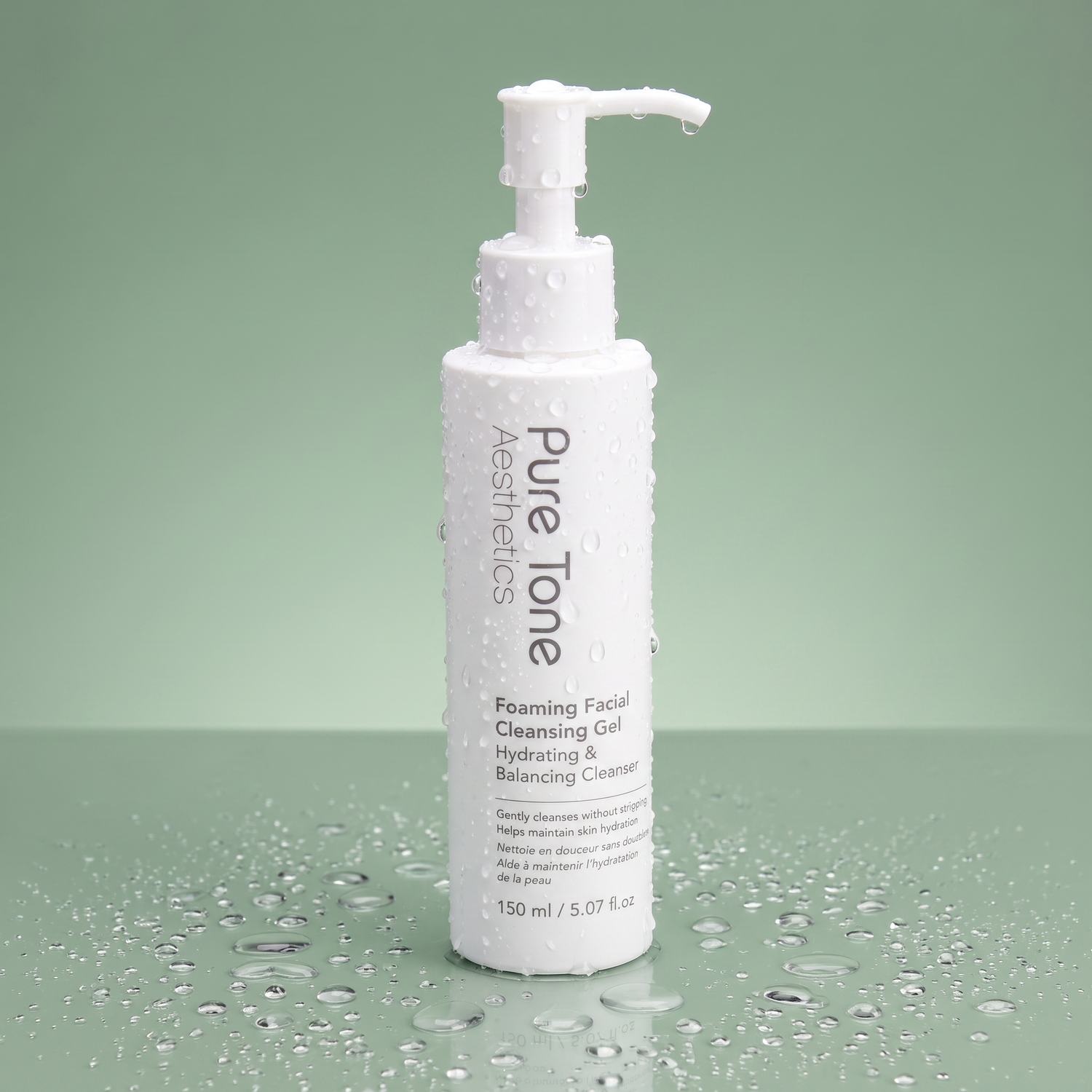 Pure Tone Aesthetics Foaming Facial Cleansing Gel standing on a reflective green surface with water droplets on the bottle and surrounding surface