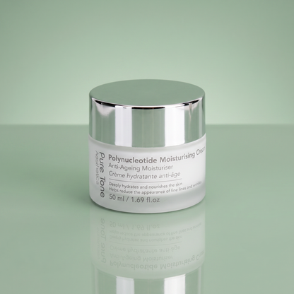 Pure Tone Aesthetics Polynucleotide Moisturising Cream jar with silver lid on a reflective soft green surface