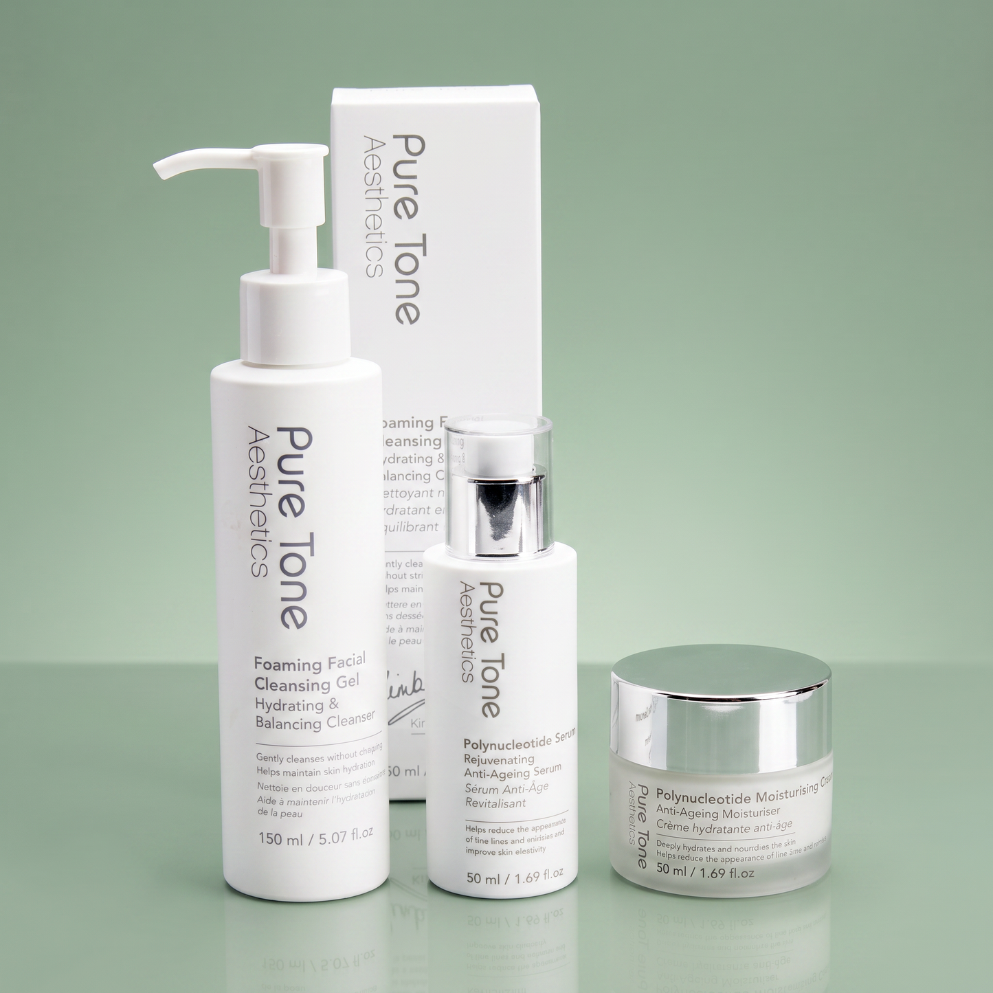 Pure Tone Aesthetics cleanser, polynucleotide serum and moisturising cream displayed with the Foaming Facial Cleansing Gel gift box on a reflective soft green surface
