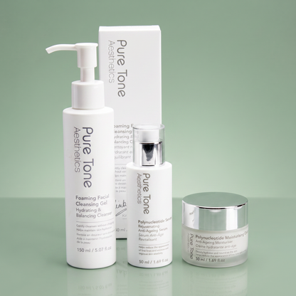 Pure Tone Aesthetics cleanser, polynucleotide serum and moisturising cream displayed with the Foaming Facial Cleansing Gel gift box on a reflective soft green surface